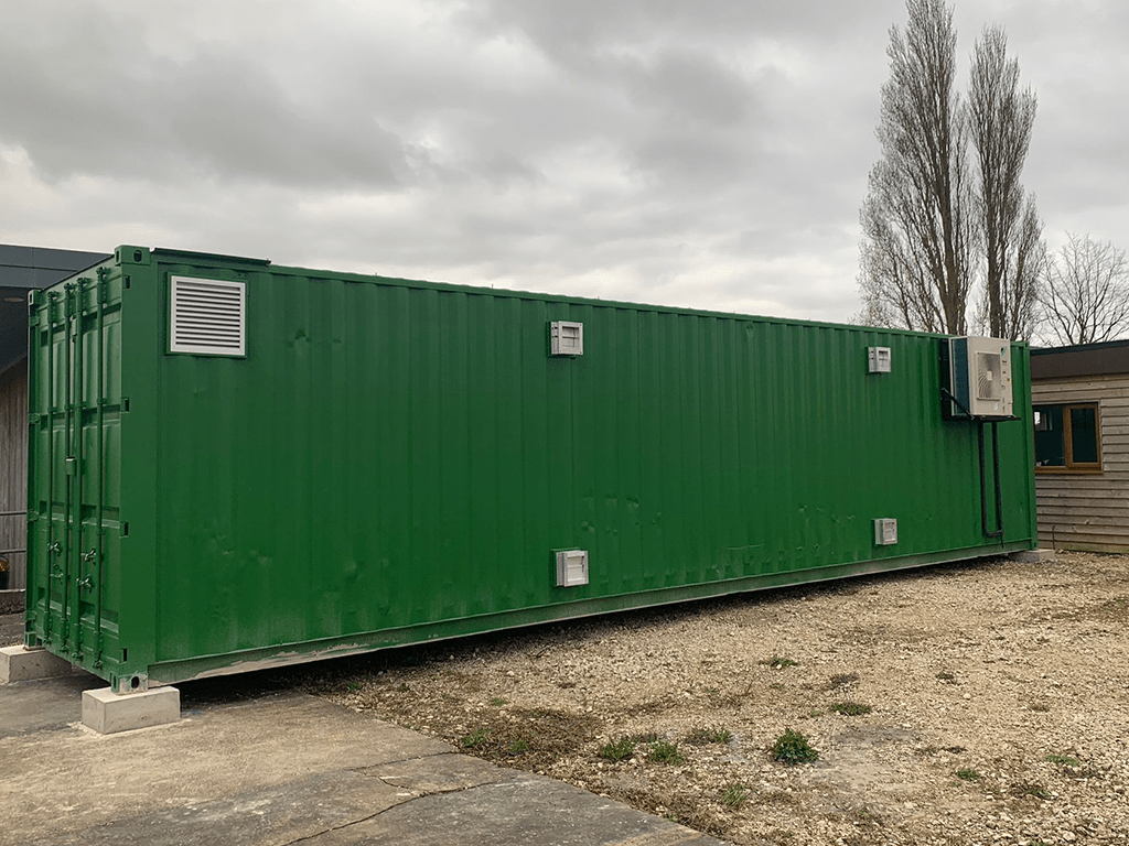 A large green Flybox insect farming container on site in the UK