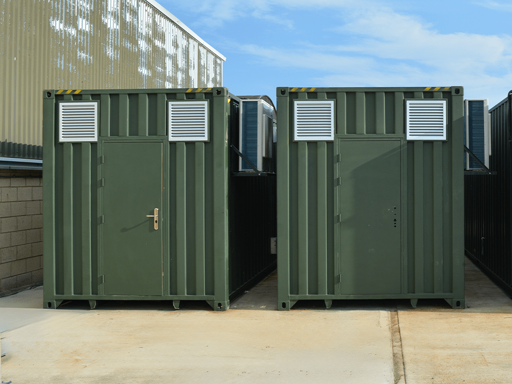Large green insect farming containers on site at waste management facility