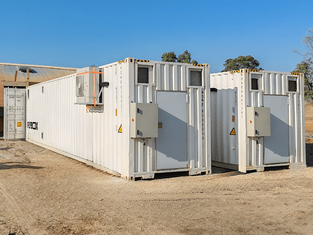 Large white insect farming containers on site at waste management facility